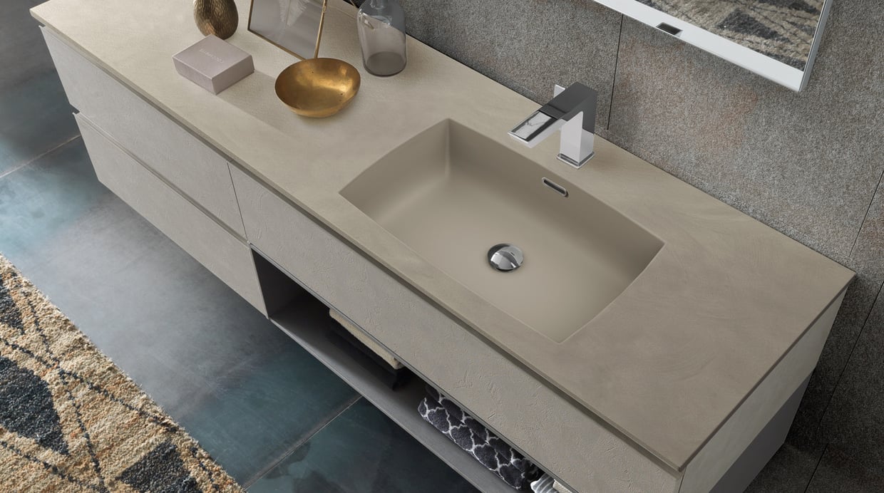 Solid surface taupe vanity with open shelf storage below