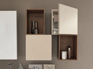 Storage cubes of different sizes on bathroom wall