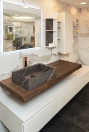 dark wood bathroom countertop with vessel and lower storage