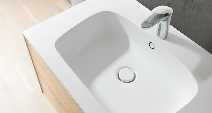 White solid-surface bathroom countertop with integrated sink