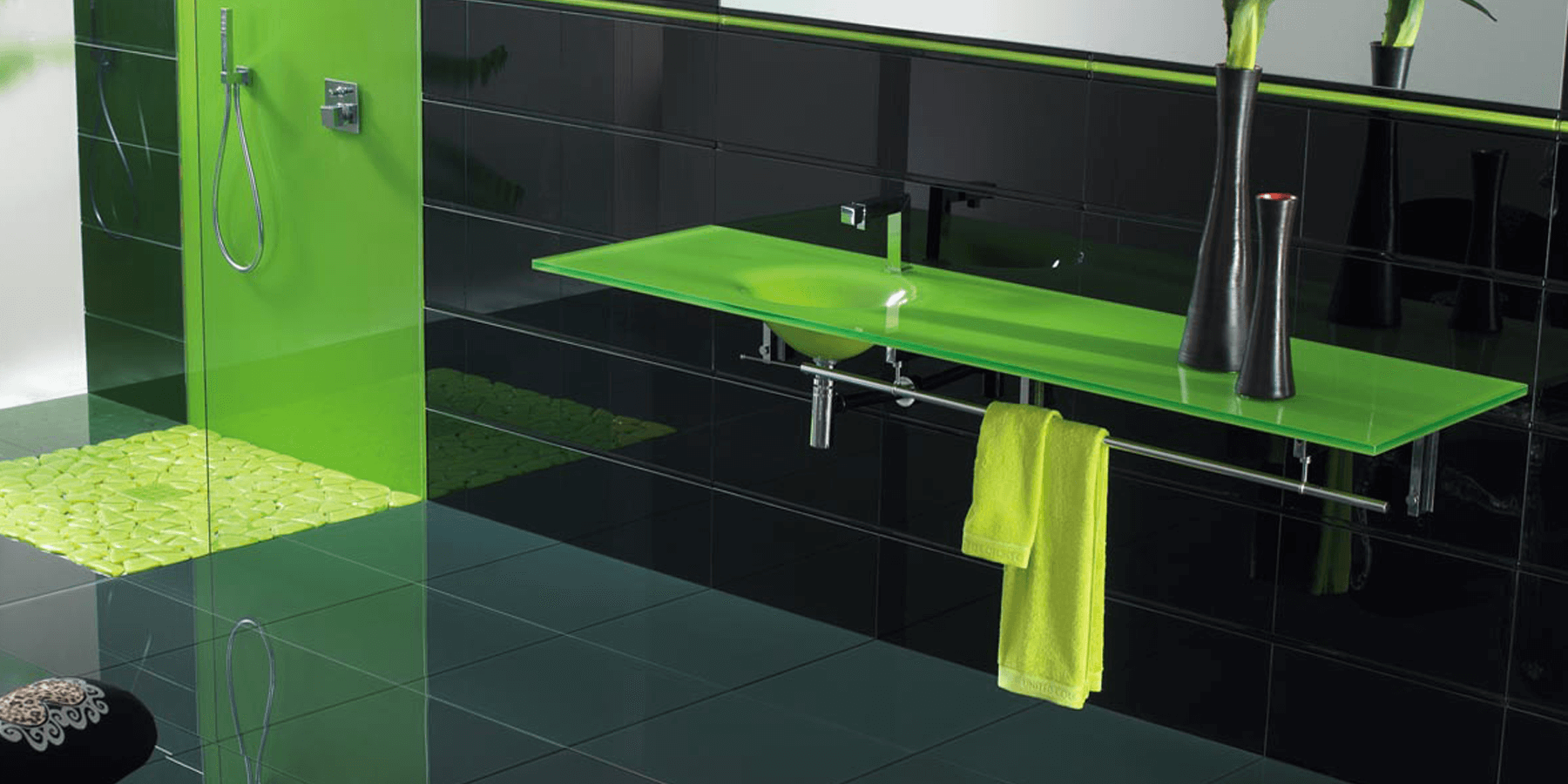 A lime green Vetro Glass Countertop in a black tiled bathroom