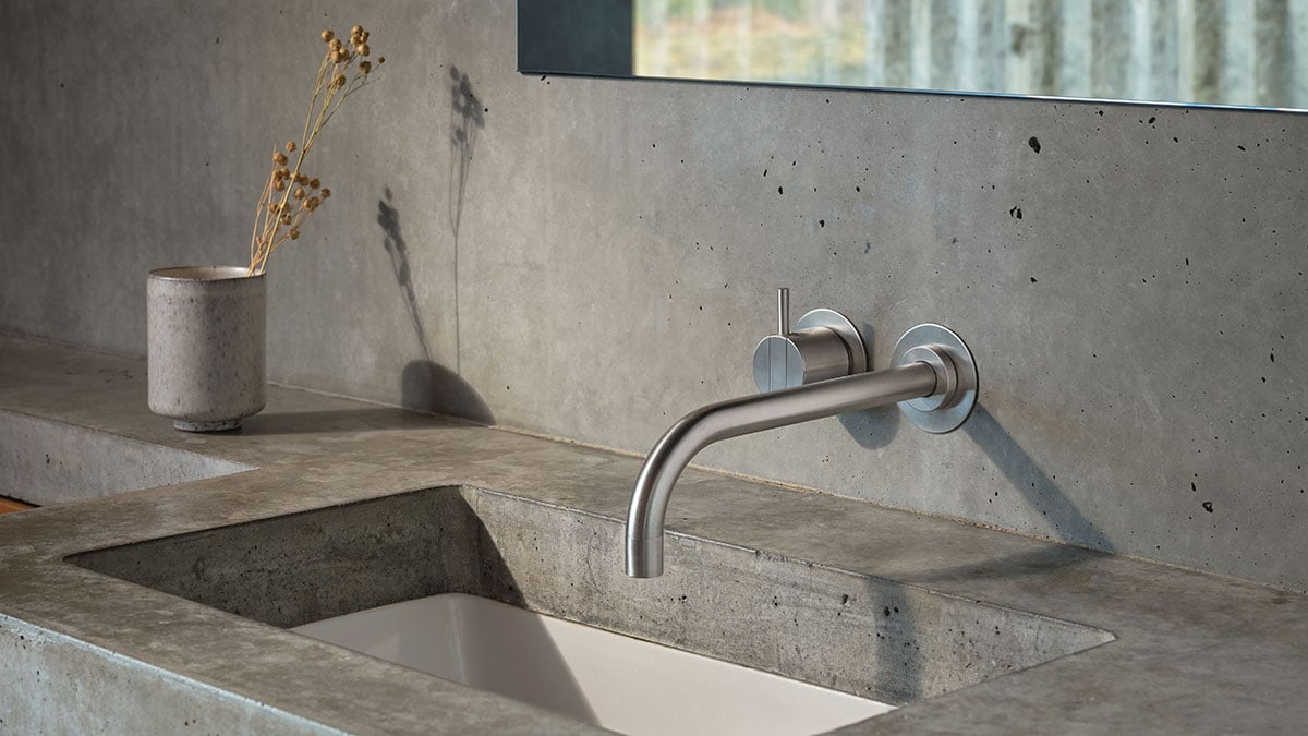 Vola 121 faucet mounted in a wall above a basin
