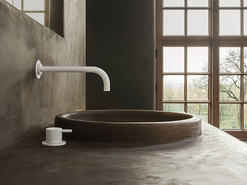 VOLA 520 white faucet mounted in a wall above a basin