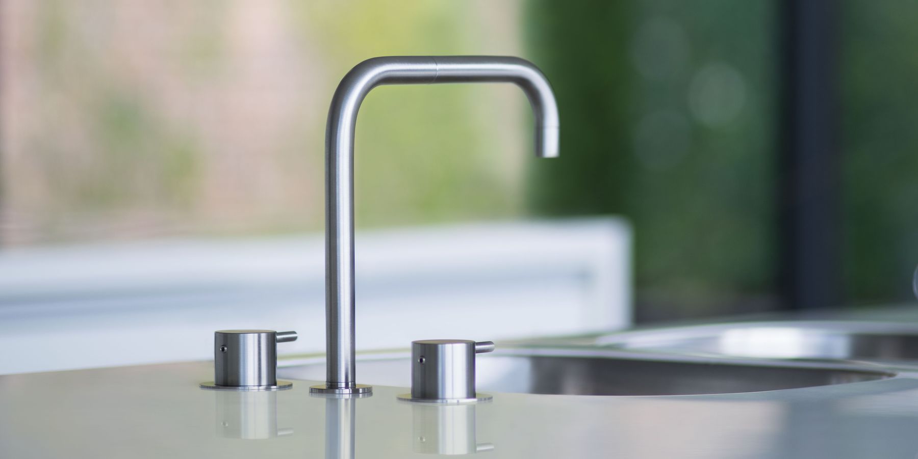 A stainless steel deck-mounted VOLA faucet