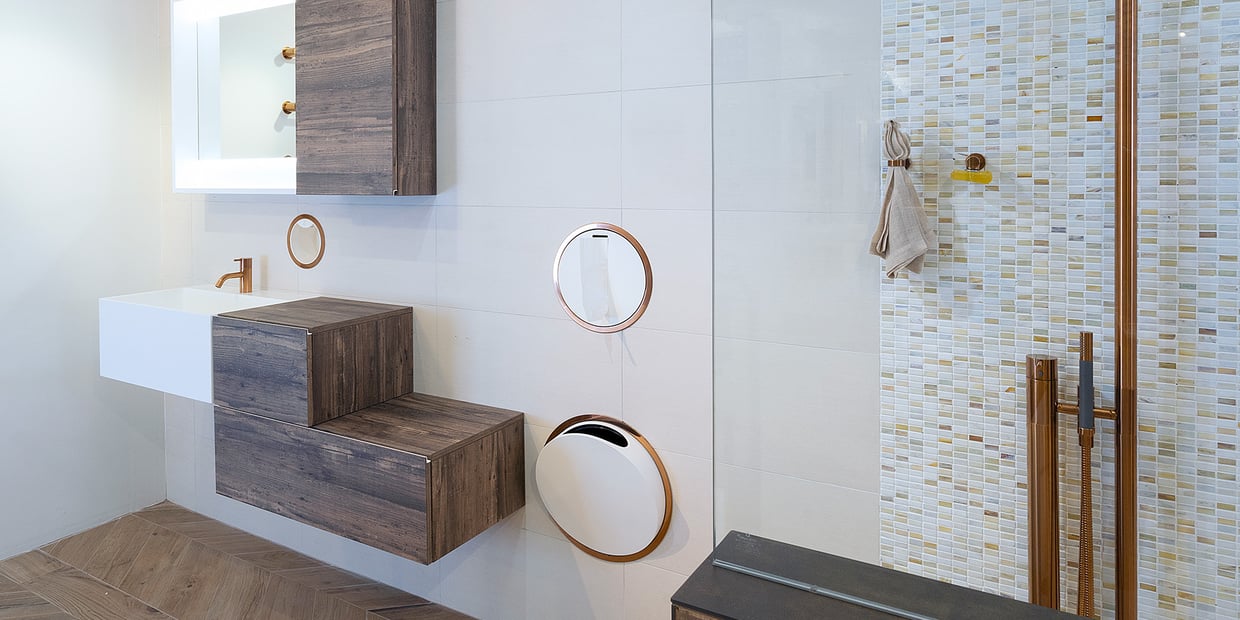 An array of gold VOLA accessories on a bathroom wall