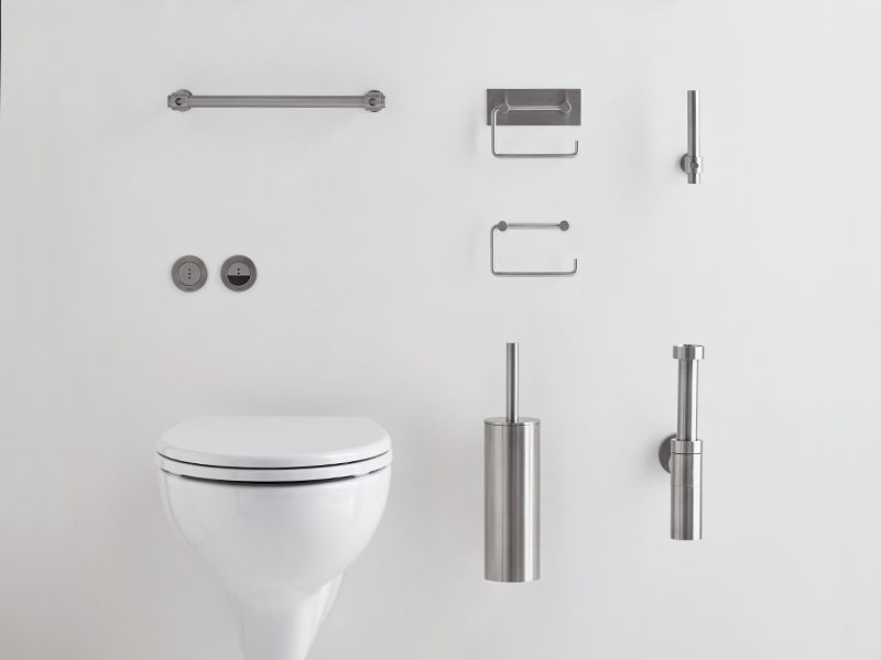 A collection of VOLA bathroom accessories mounted on the wall