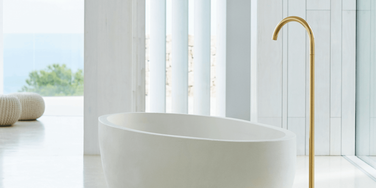 Bathtub with large gold VOLA tub filler
