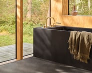 gold VOLA deck-mounted tub filler