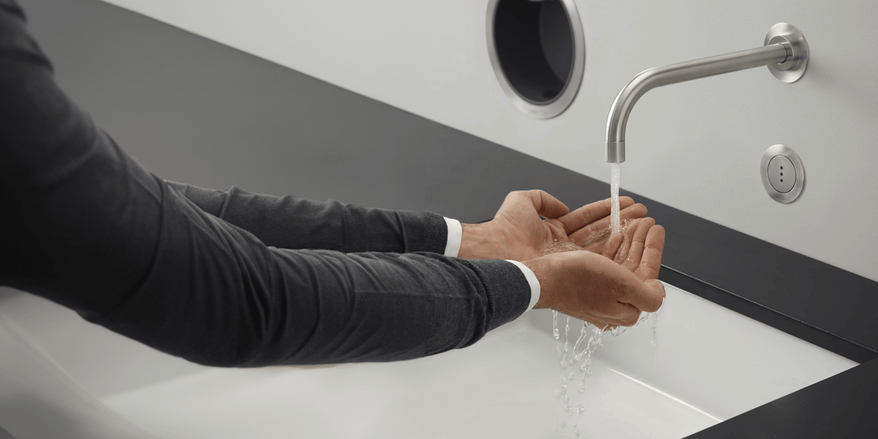 A person using a hands-free VOLA faucet