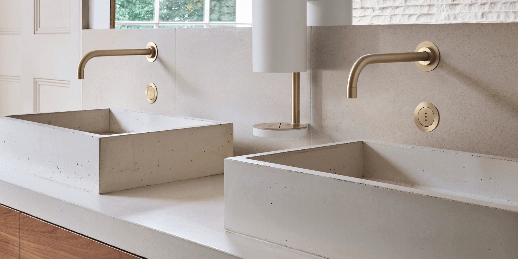 Double gold VOLA hands-free wall-mount faucets