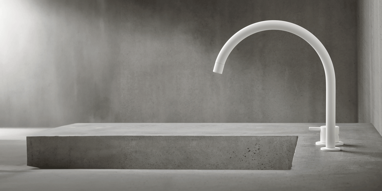 A white deck-mounted VOLA kitchen faucet