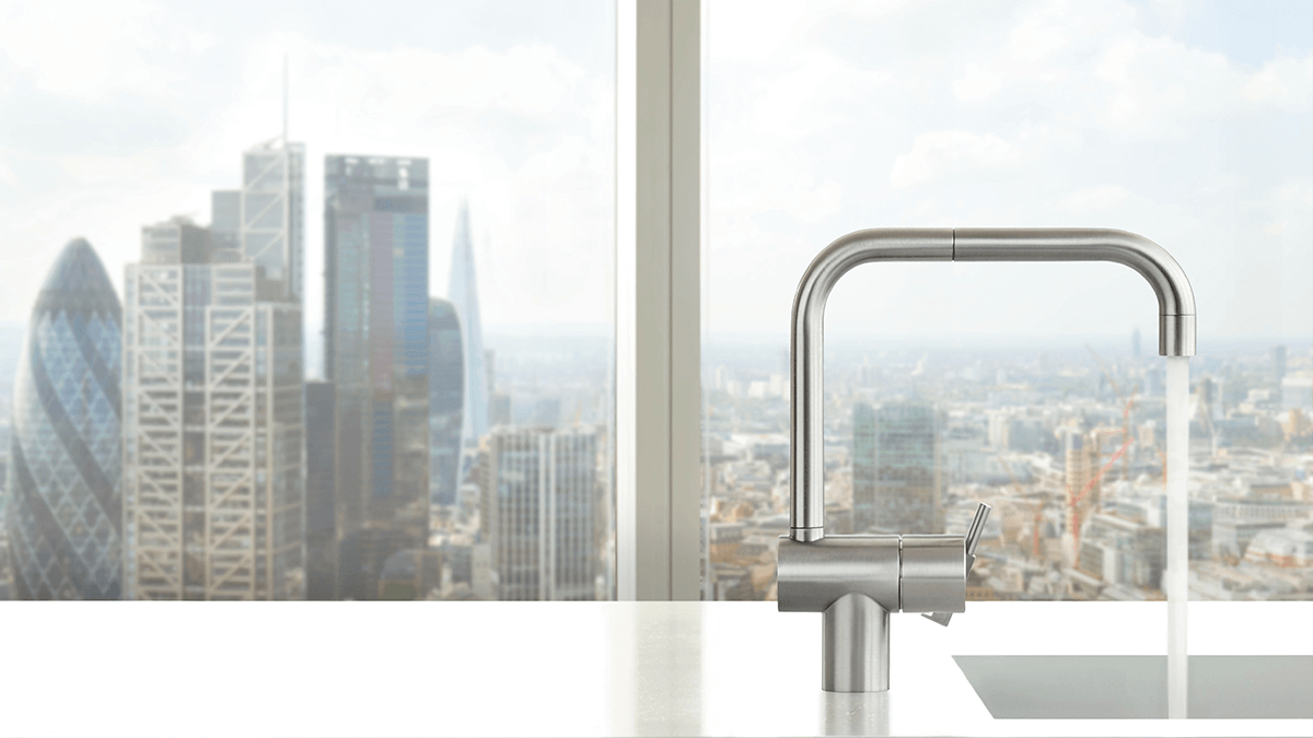Vola chrome kitchen faucet with cityscape as background