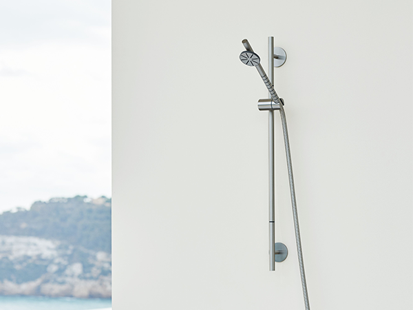 A wall-mounted adjustable-height VOLA showerhead
