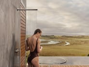 A person showering outdoors on a luxury deck