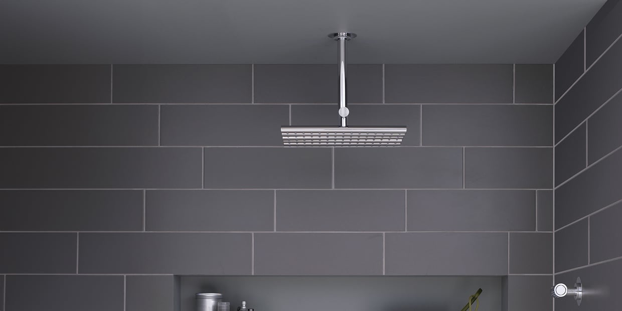 VOLA rain-head shower system in a grey shower