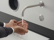 Closeup of hands using a touch-free VOLA faucet