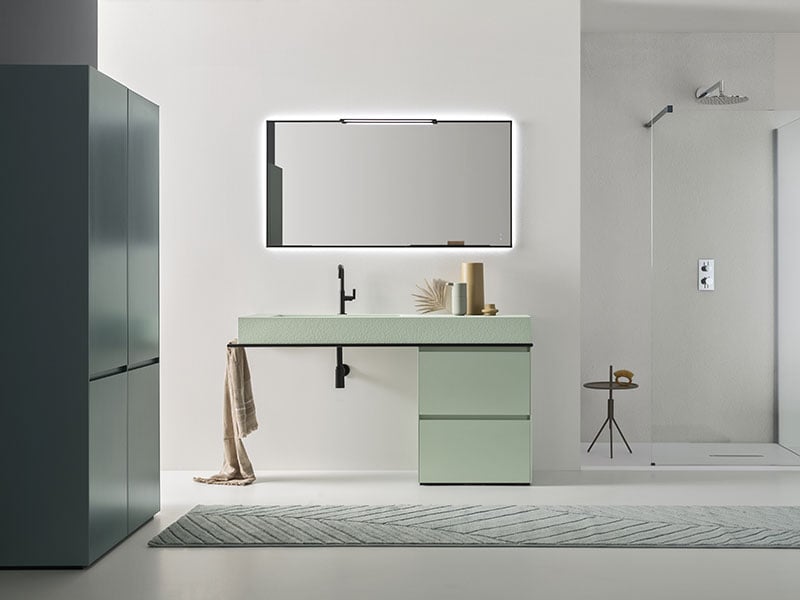 Tuby backlit bathroom mirror above green vanity