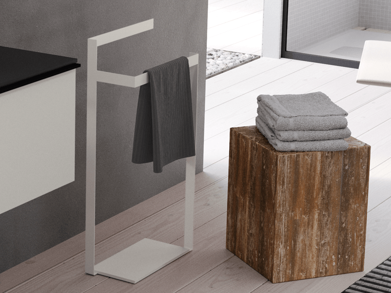 Single white freestanding towel rail next to a low wood table