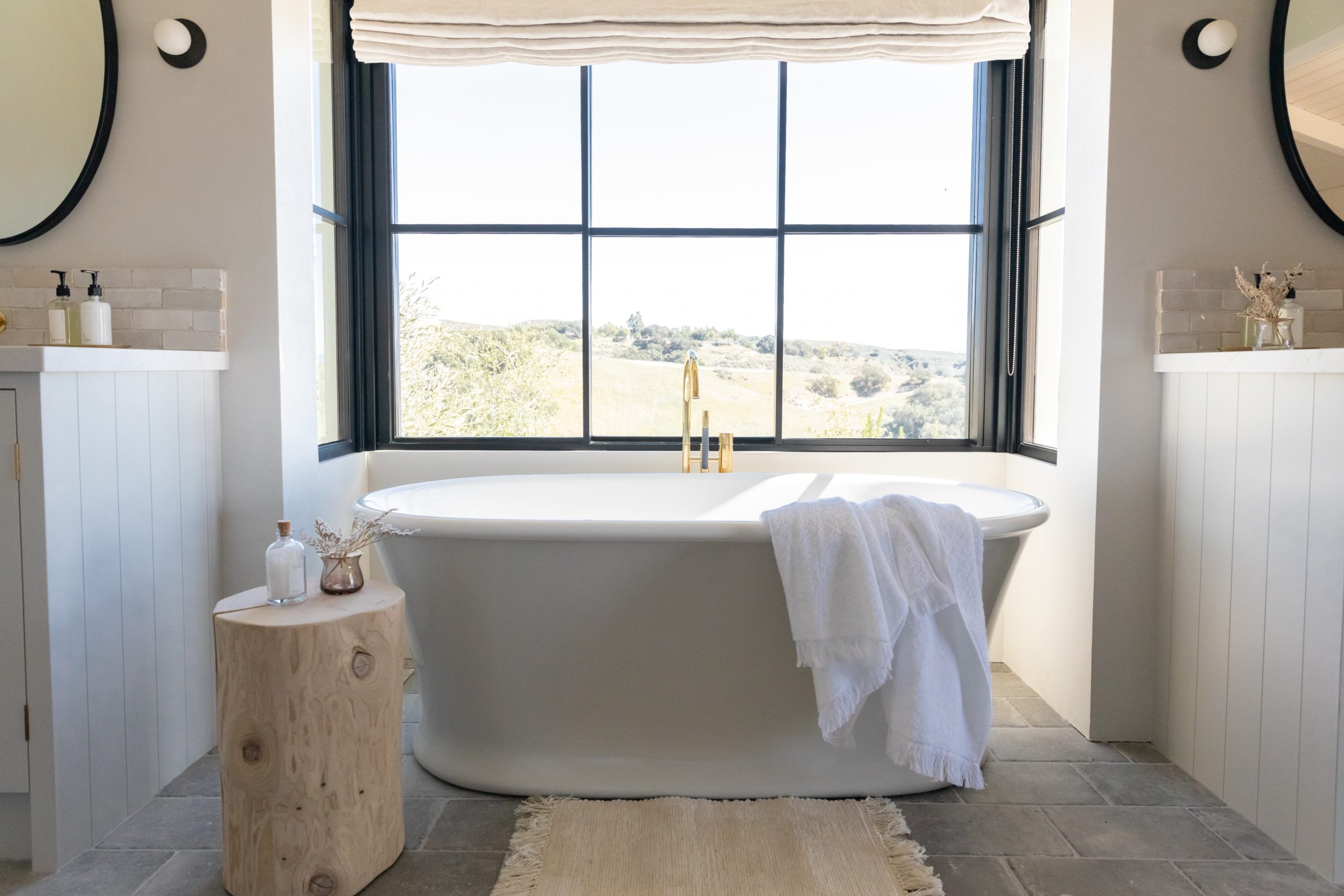 Gold VOLA tub filler with freestanding tub