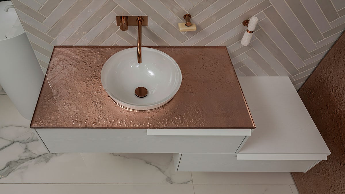 Copper-colored Vetro glass countertop in a luxury bathroom