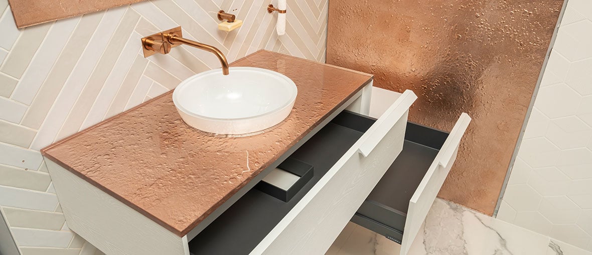 Copper-colored Vetro glass countertop in a luxury bathroom