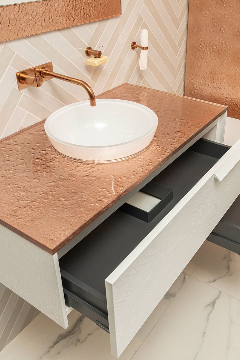 Copper-colored Vetro glass countertop with a white cabinet