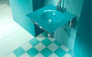 Aqua-colored Vetro glass countertop and a floor with alternating aqua and white tiles