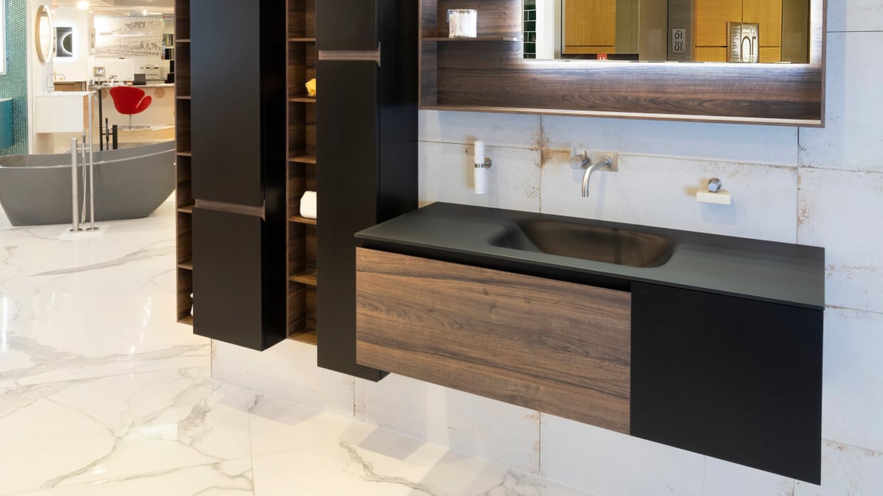 Black bathroom vanity with wood front panel