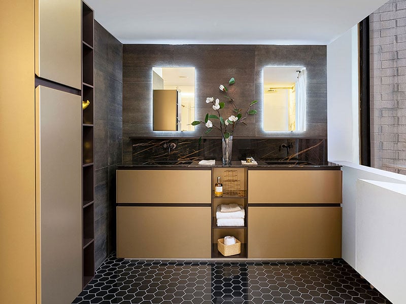 Gold bathroom vanities and matching wall storage