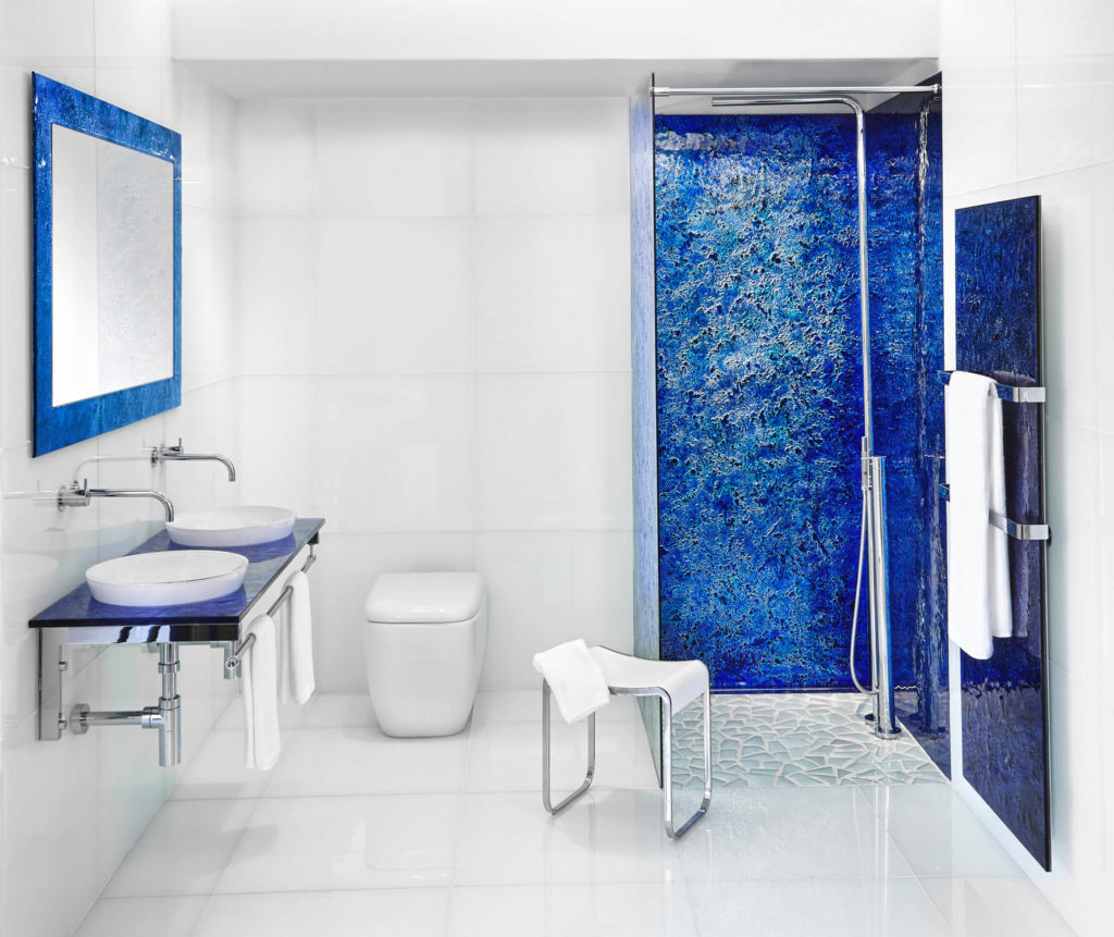 Luxury bathroom with blue Vetro glass details and paneling