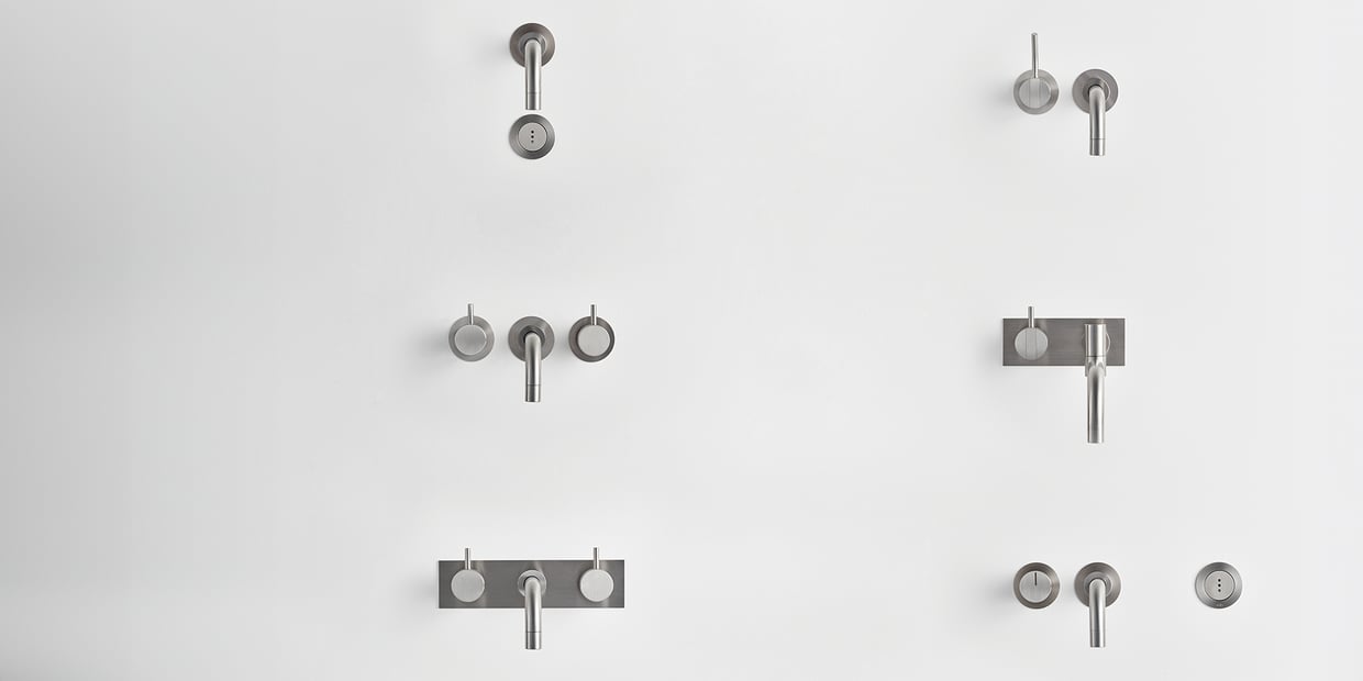 A selection of VOLA faucets displayed on a wall