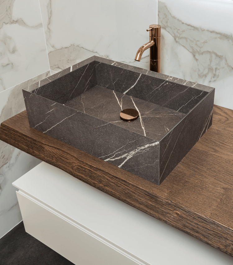 marble-look bathroom vessel on wood-look countertop