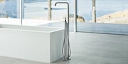floor-mounted chrome tub filler with hand shower