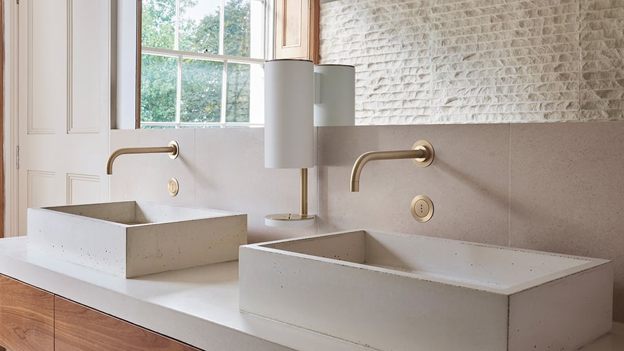 Gold VOLA hands-free bathroom faucets