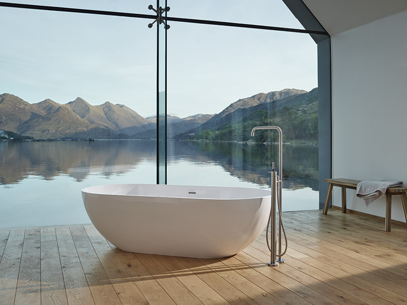Modern VOLA tub filler with white oval bathtub